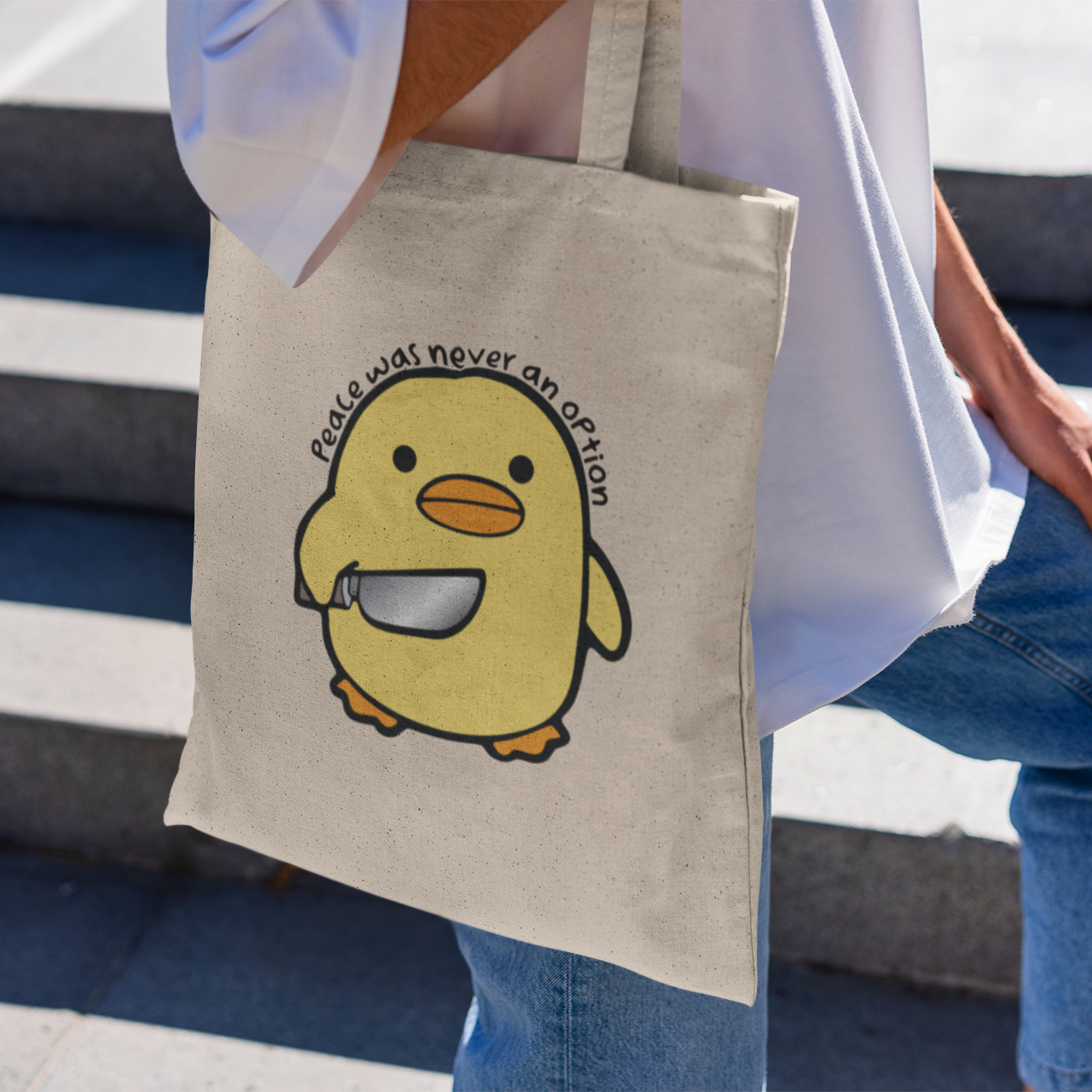 a person carrying a bag with a cartoon penguin on it