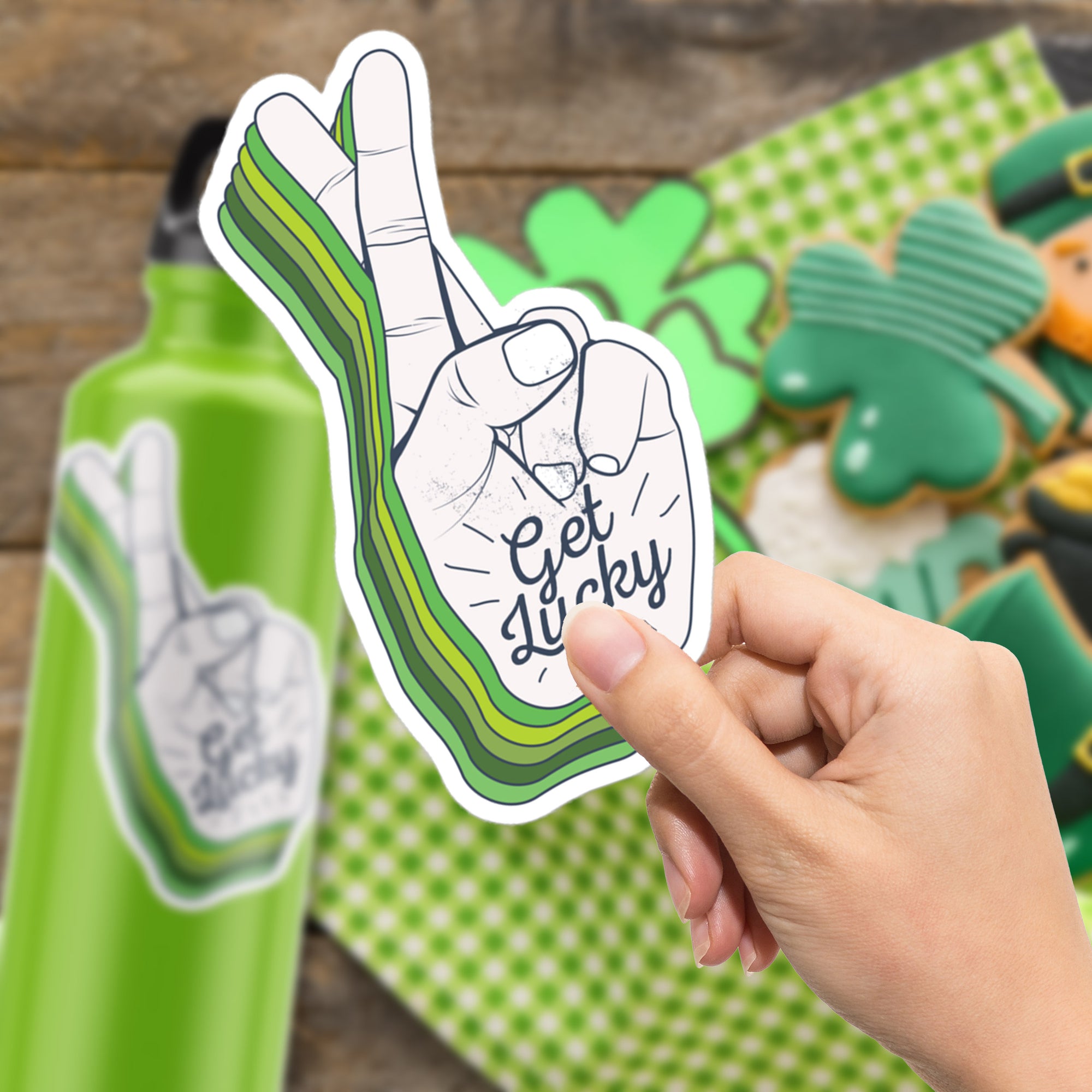 a hand holding up a sticker of a green bottle