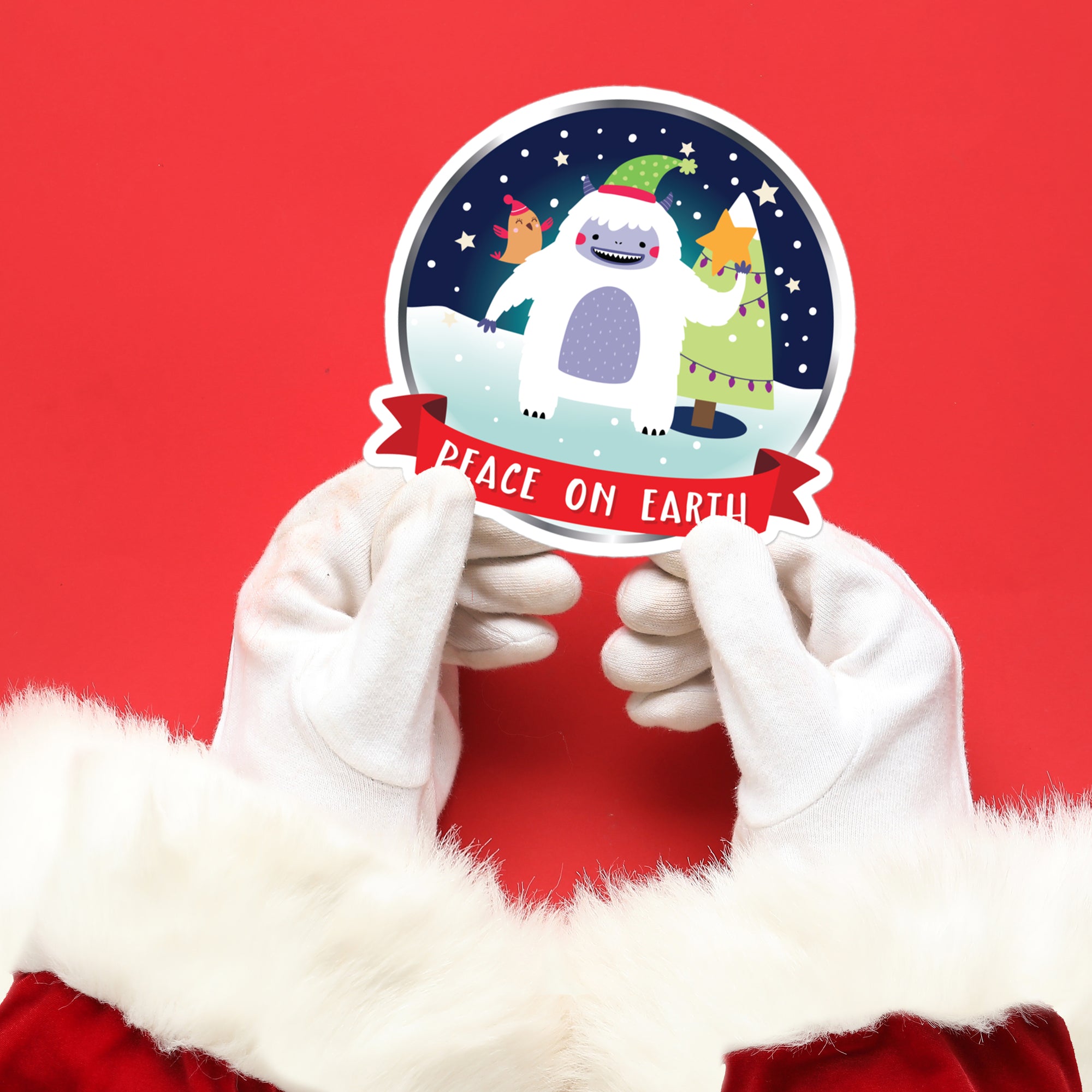 a person in a santa suit holding up a sticker