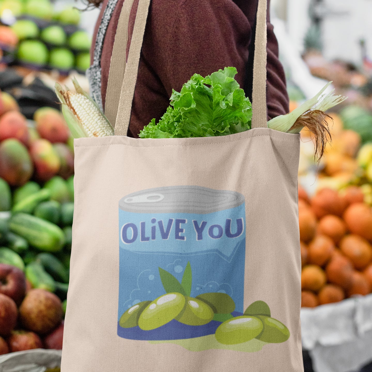 a woman carrying a grocery bag with vegetables in it