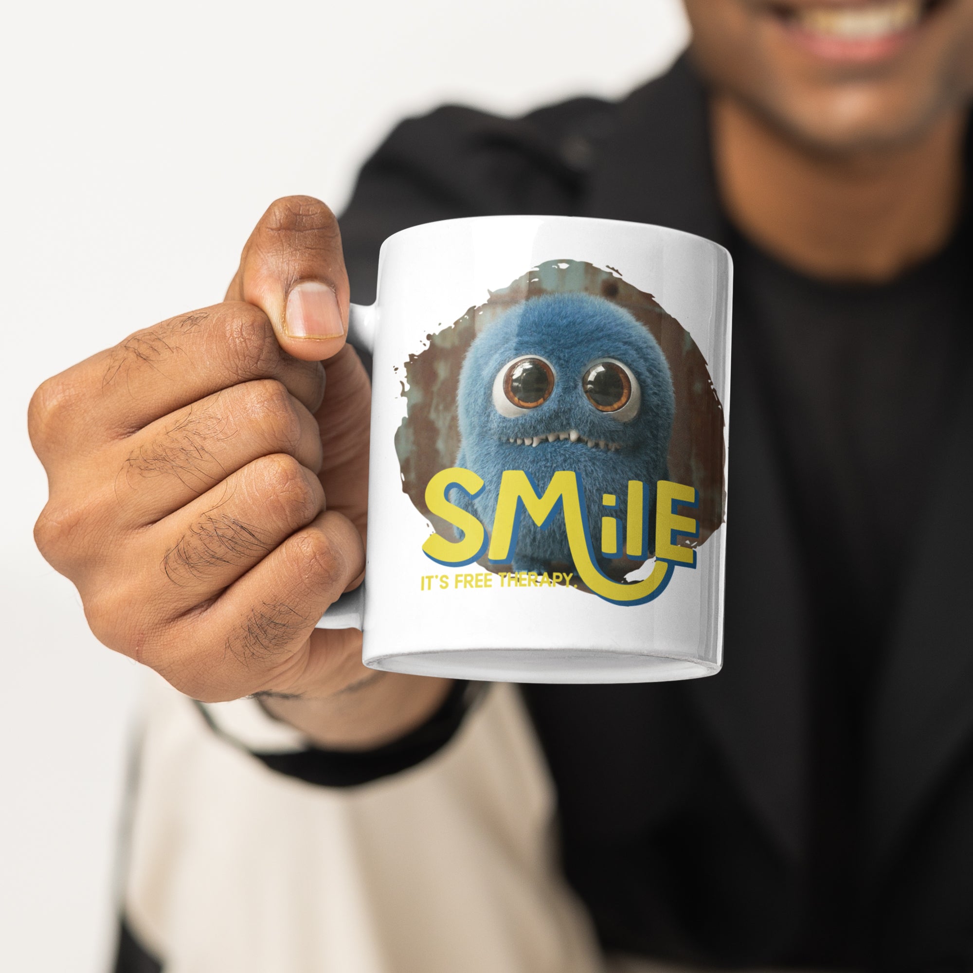 a man holding a coffee mug with a smile on it