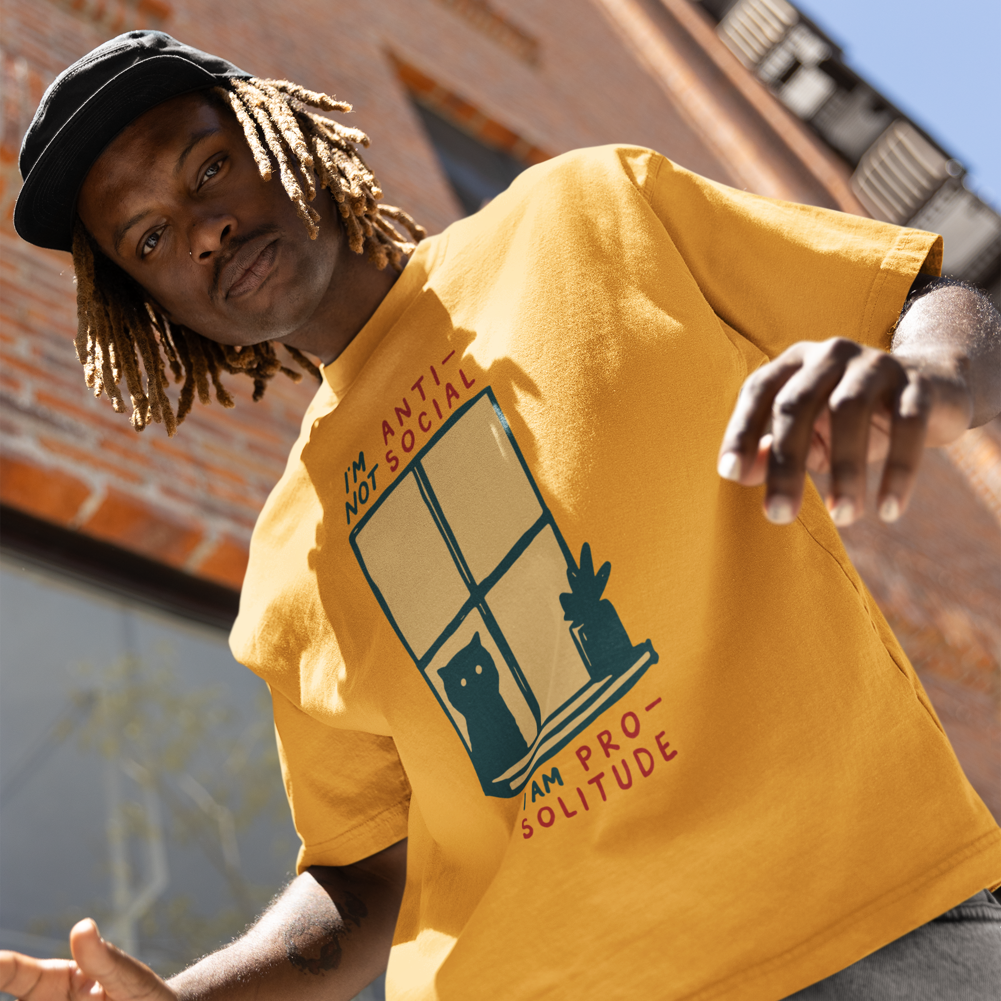 a man in a yellow shirt is holding a skateboard