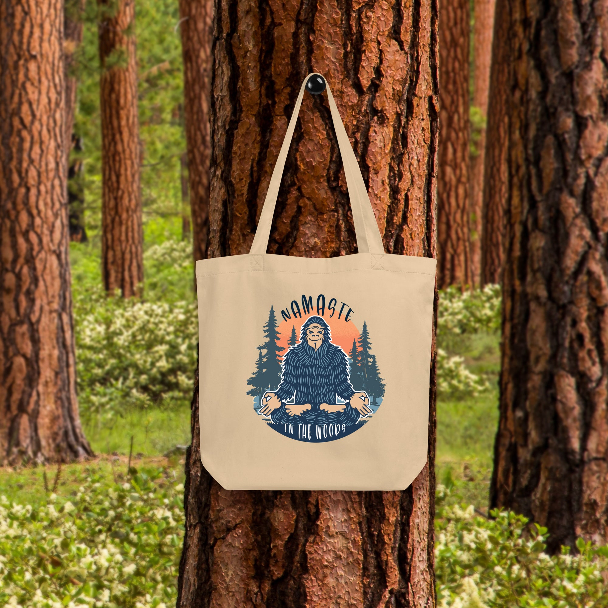 a tote bag hanging on a tree in a forest