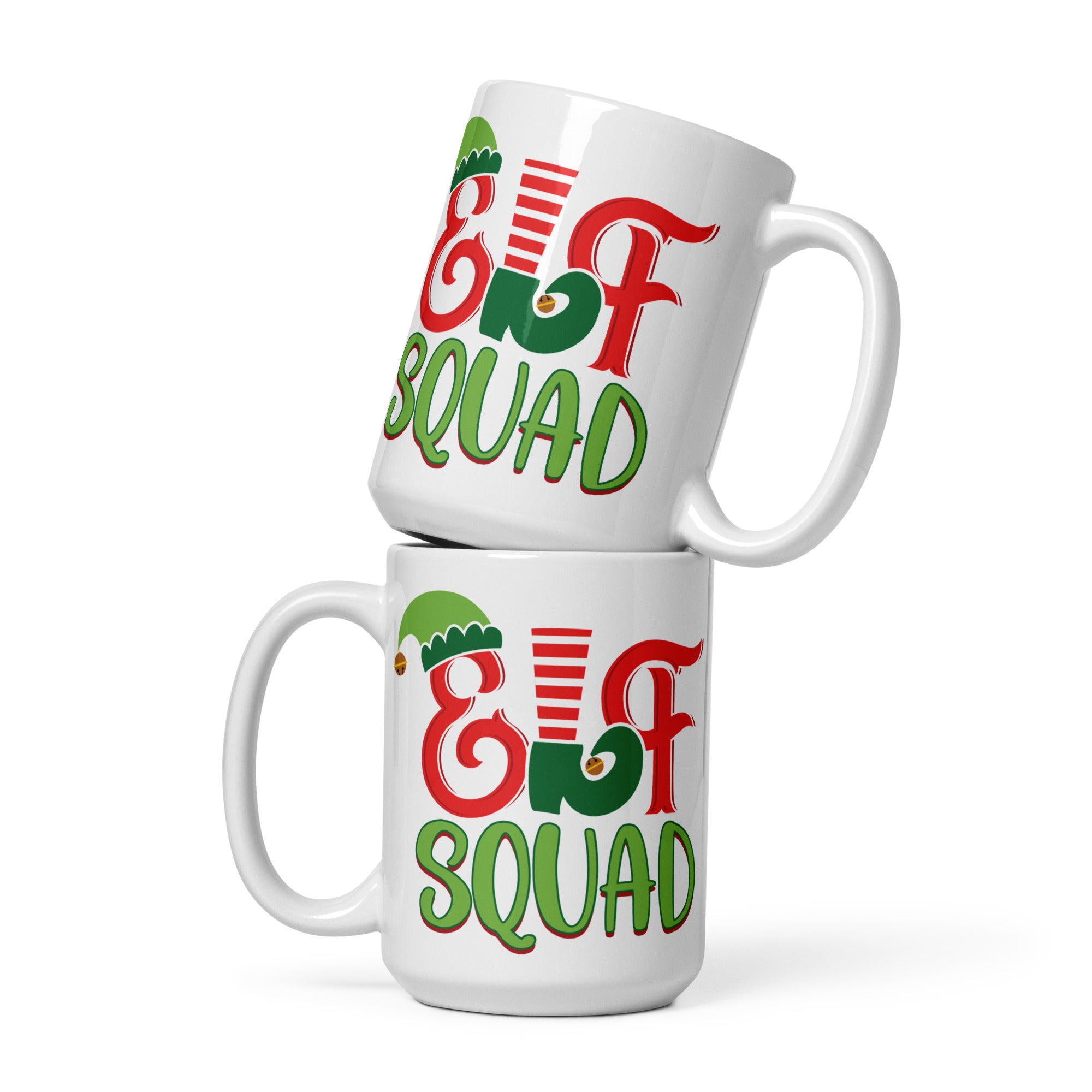 two white coffee mugs with the words christmas and a christmas tree