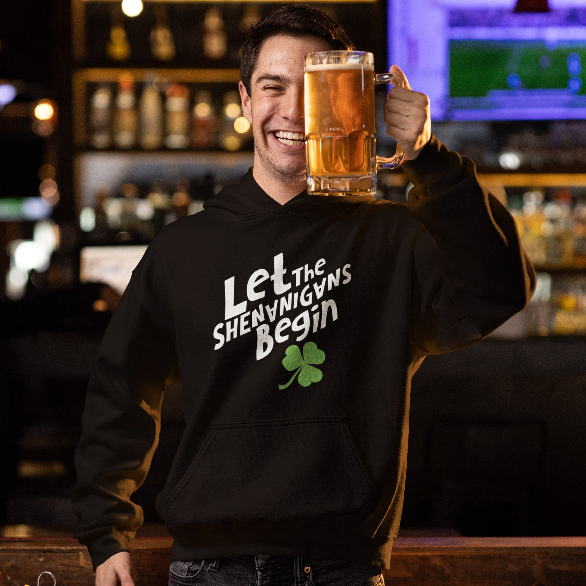 a man is holding a mug of beer