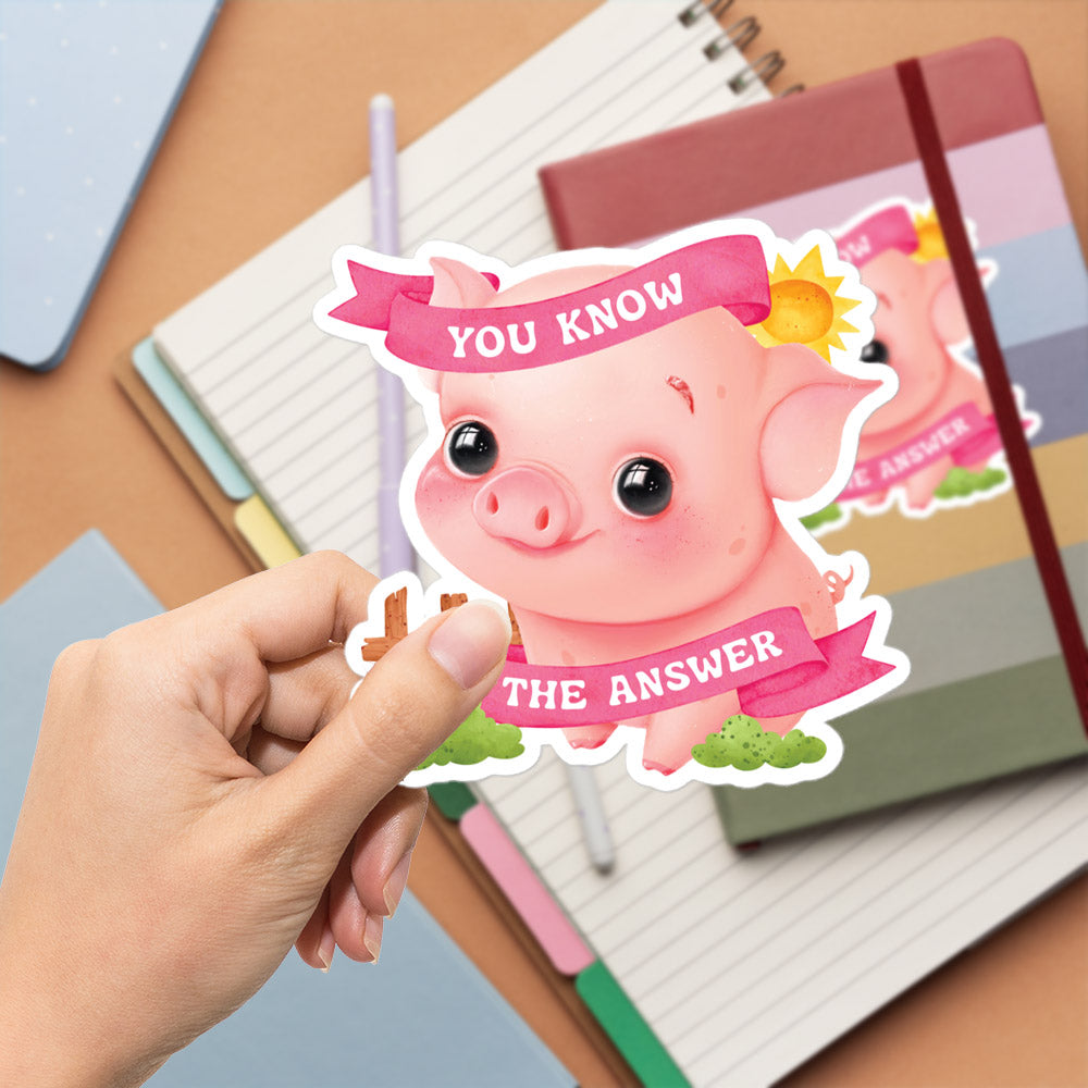 A hand is holding a sticker with a cartoon pig and the text "You know the answer" written on it.
