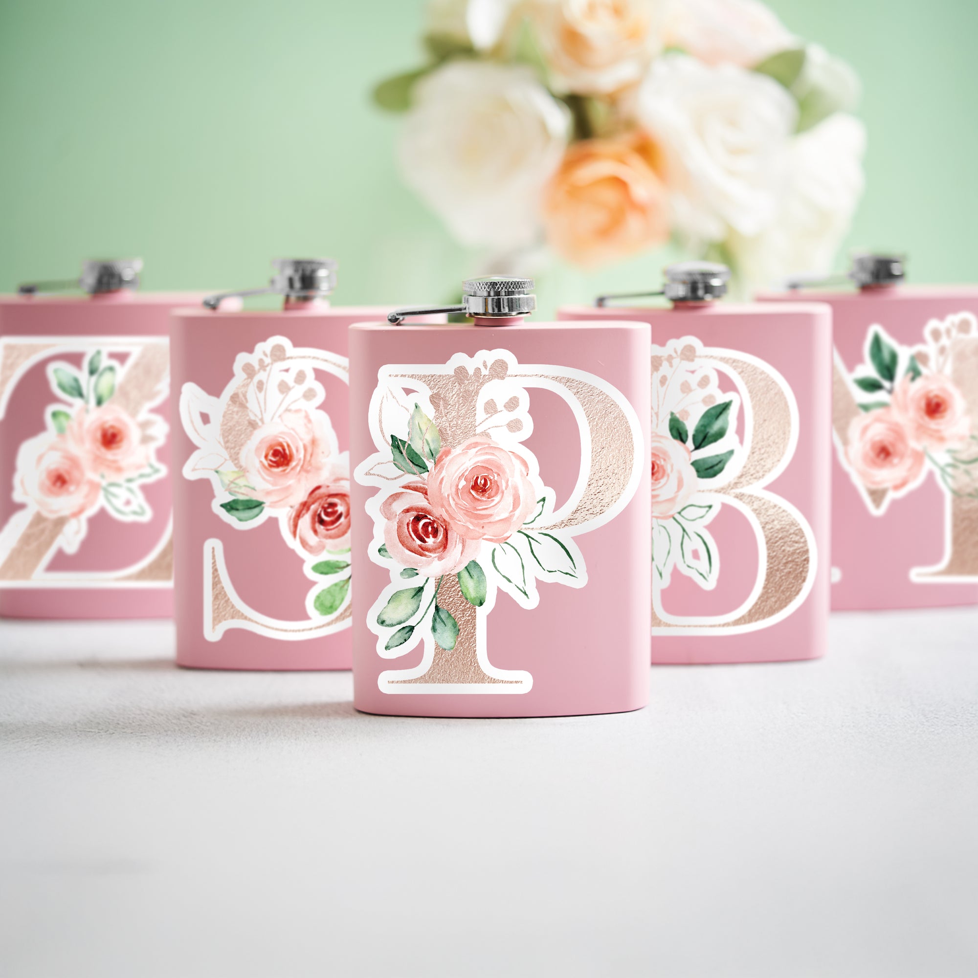 a group of pink flasks sitting on top of a table