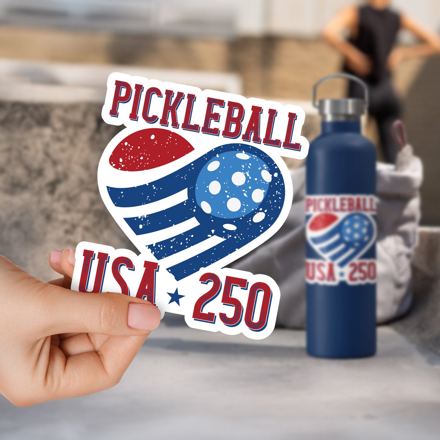 a person holding up a sticker that says pickleball usa 250