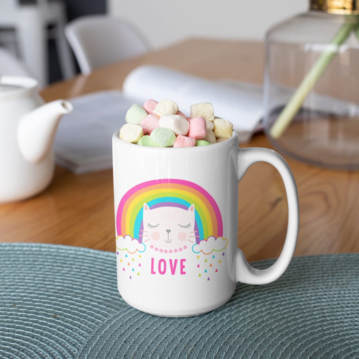 a coffee mug filled with marshmallows sitting on a table