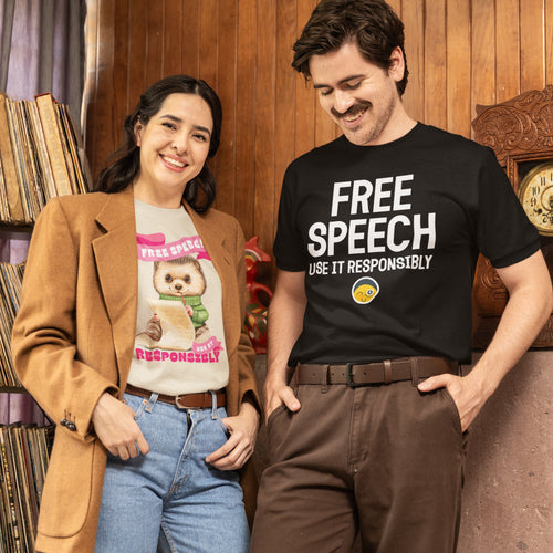 A man and a woman are standing together, both smiling. The man is wearing a black t-shirt with the text "FREE SPEECH USE IT RESPONSIBLY" printed on it. The woman is wearing a t-shirt with a cartoon image of a dog and the text "Free Speech Responsibly".