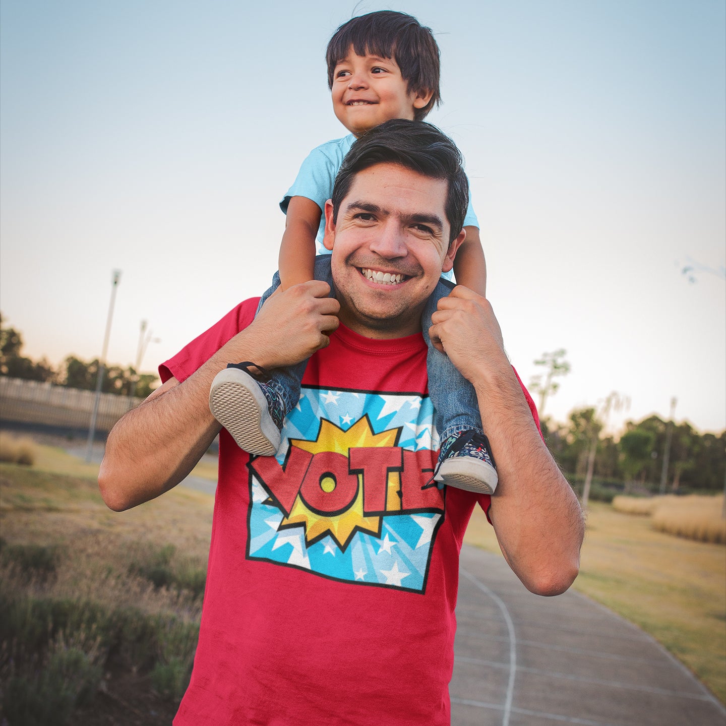 a man holding a young boy on his shoulders