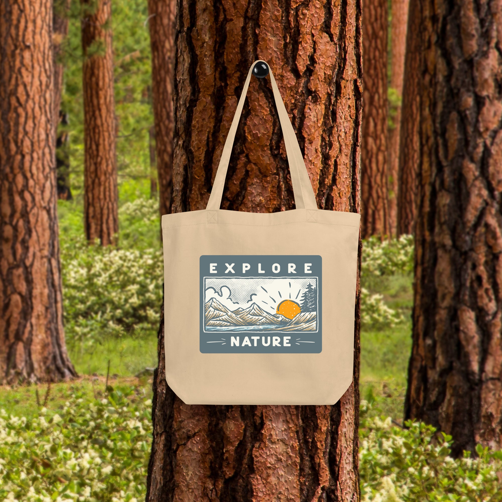 a tote bag hanging on a tree in a forest