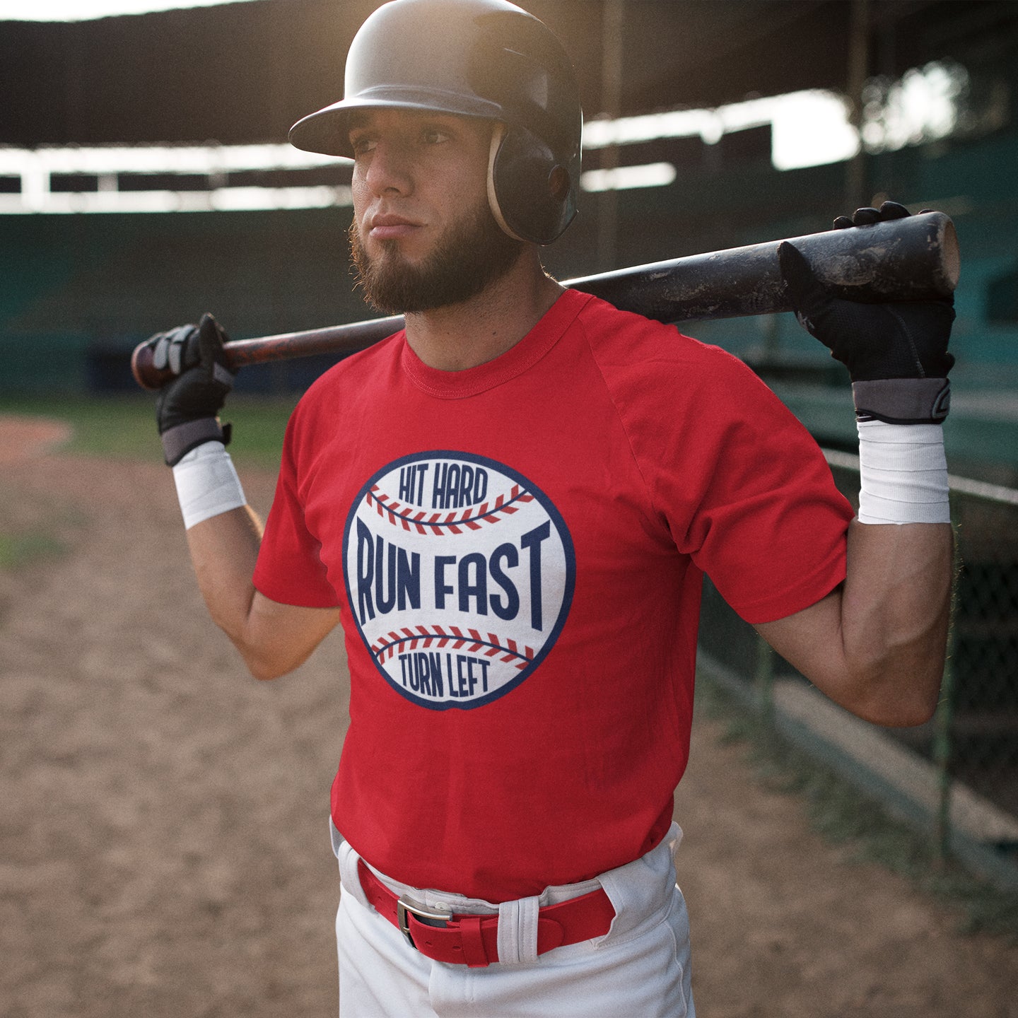 a man in a red shirt holding a baseball bat