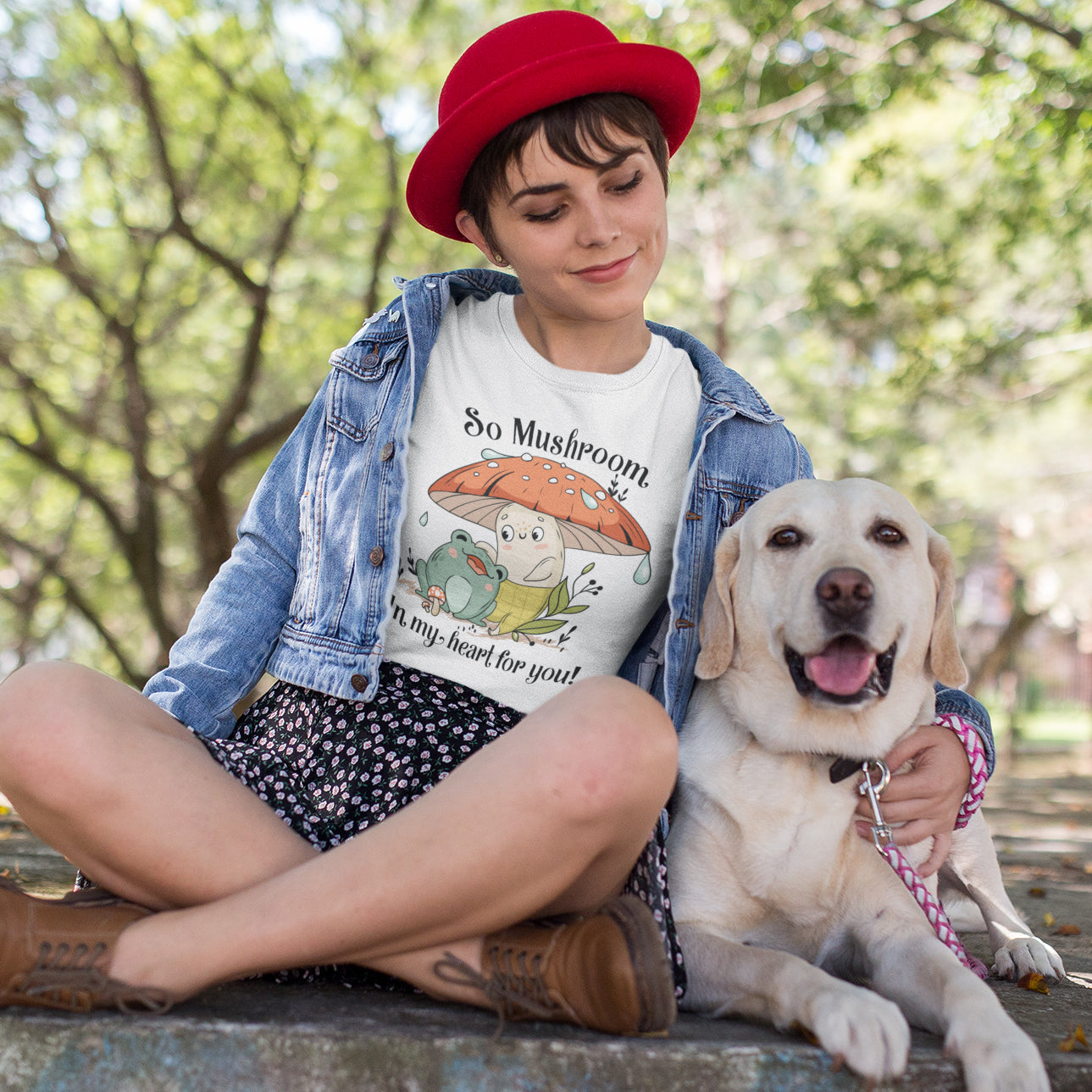 a woman sitting on the ground with a dog