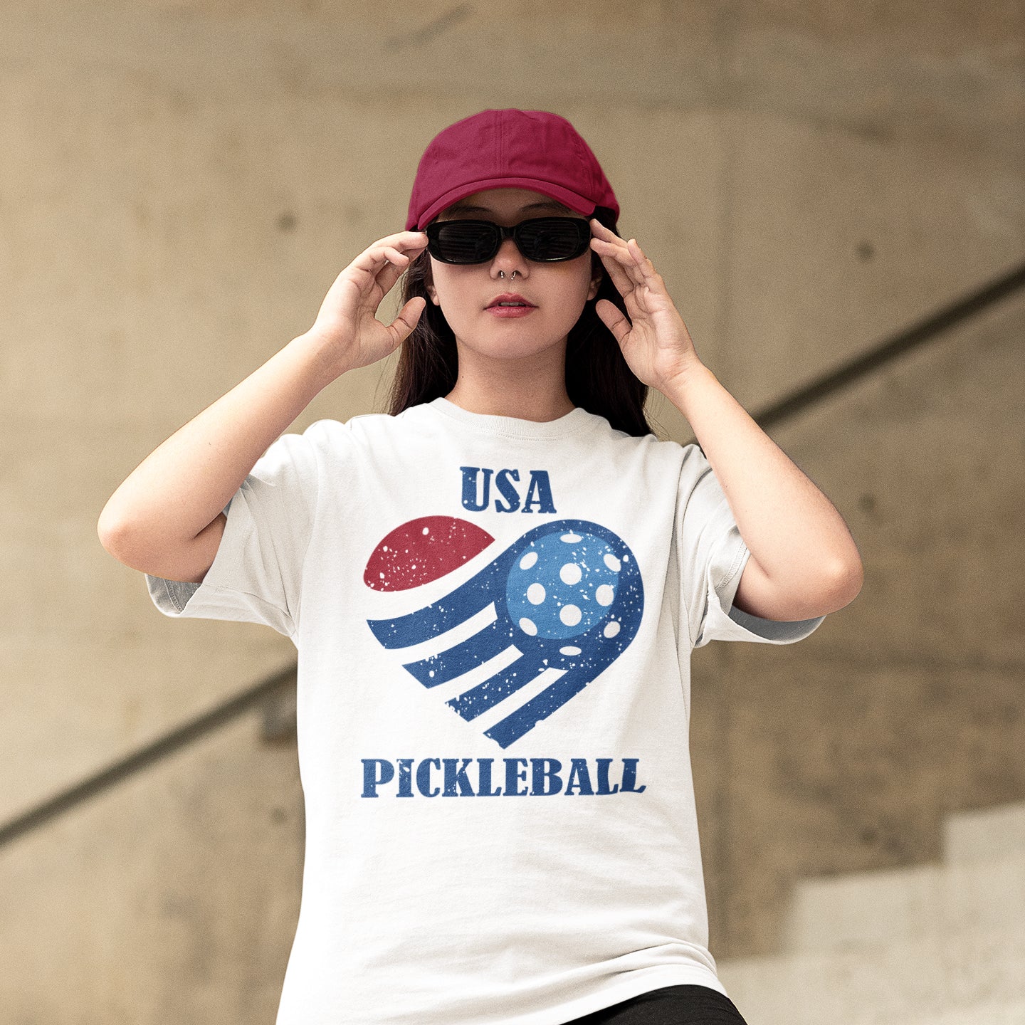 a woman wearing a usa pickleball t - shirt