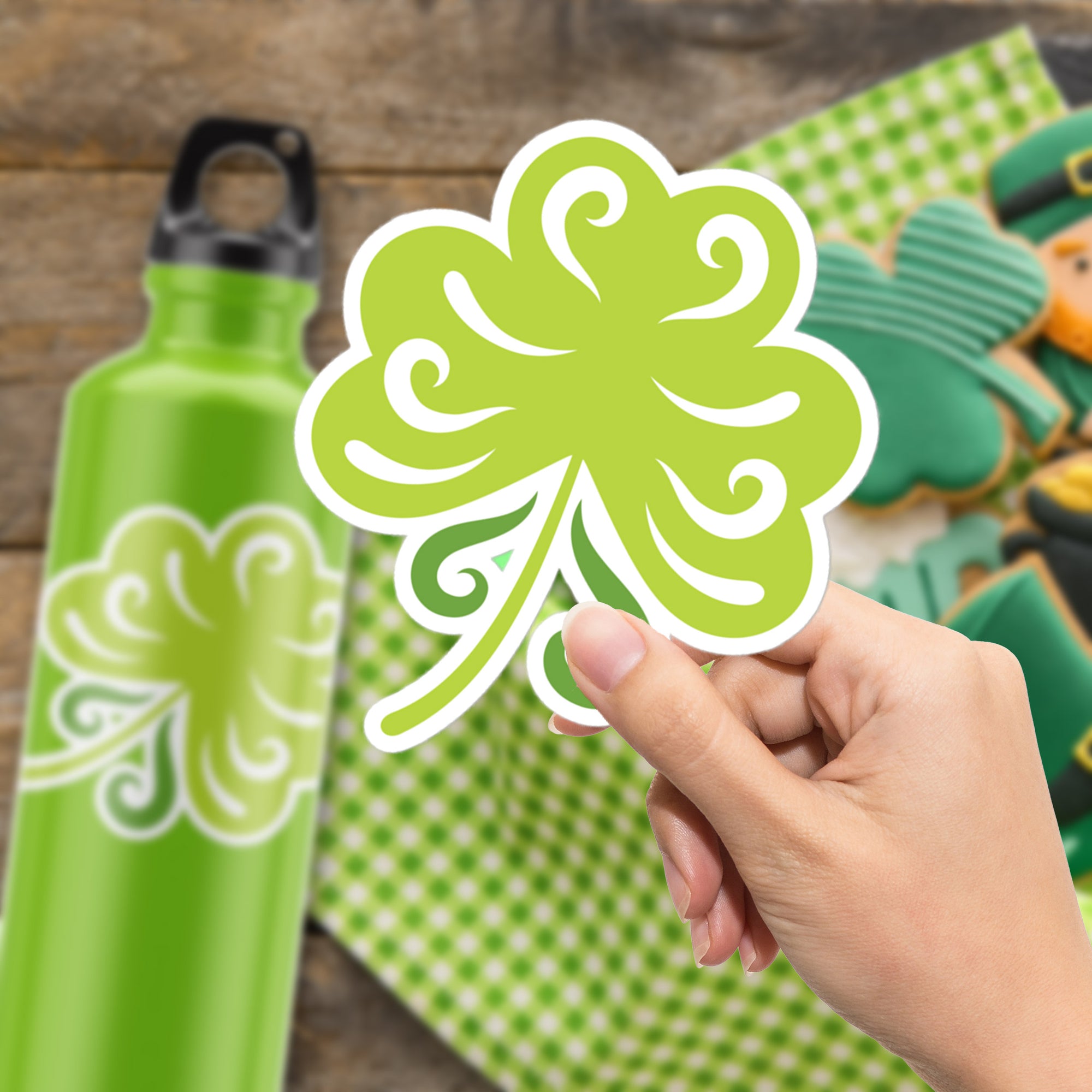 a person holding a green shamrock shaped sticker