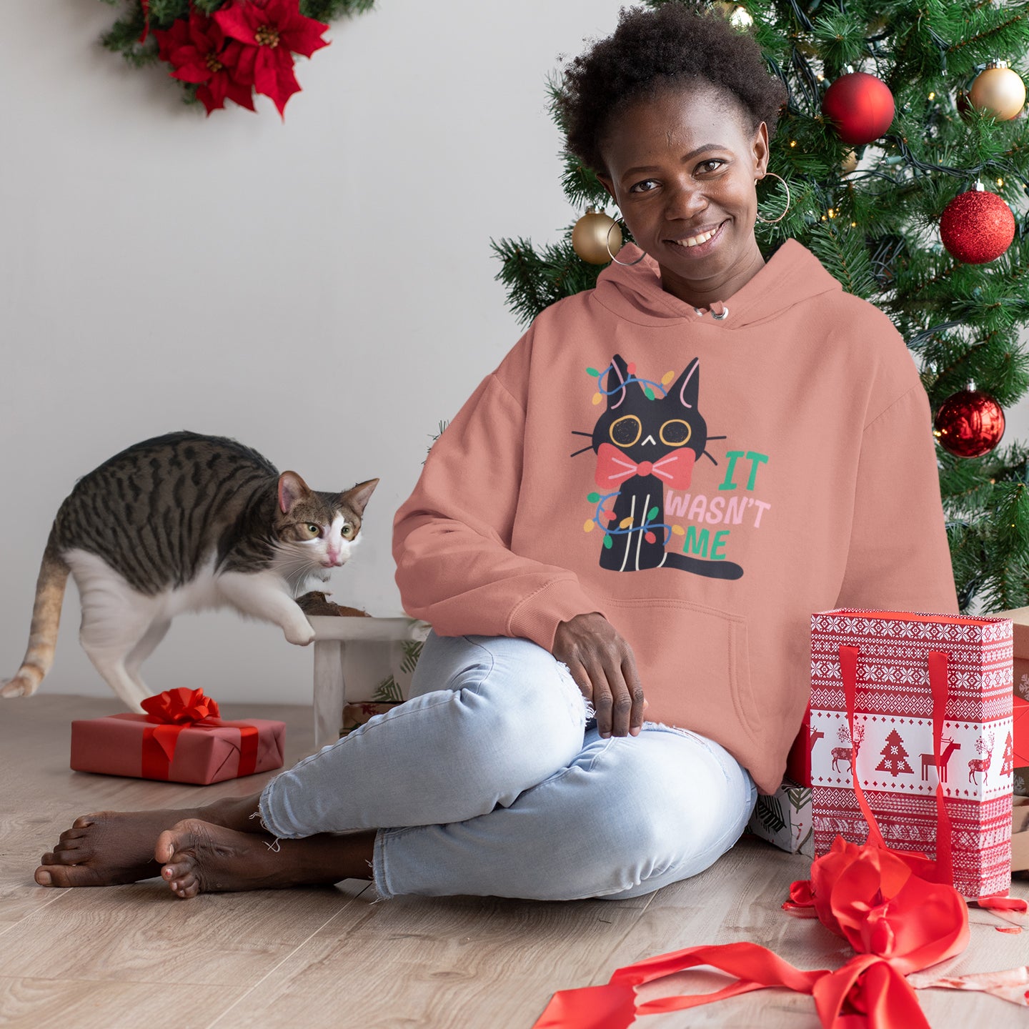 a woman sitting on the floor with a cat next to her