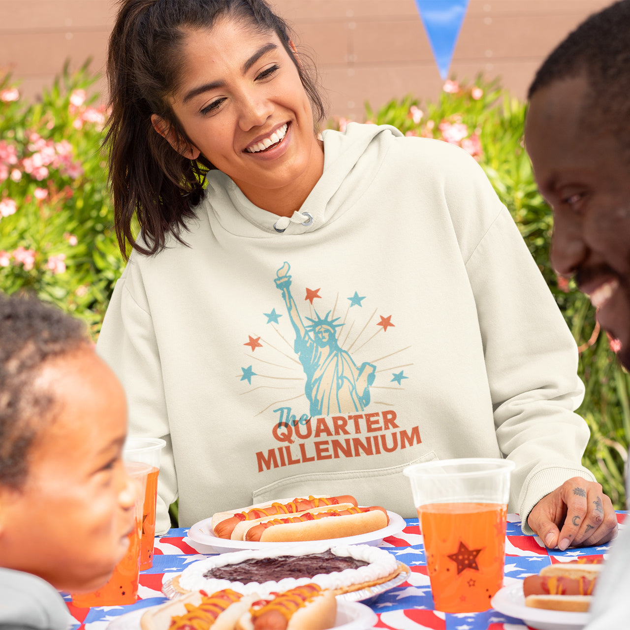 a woman sitting at a table with two children