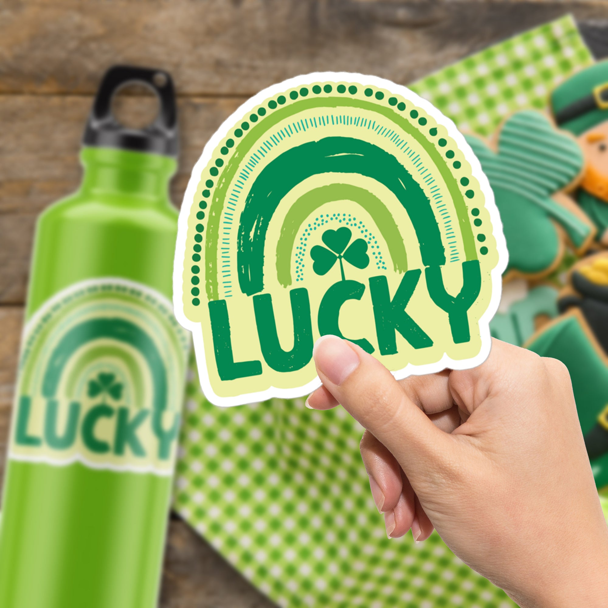 a hand holding a sticker that says lucky next to a st patrick's