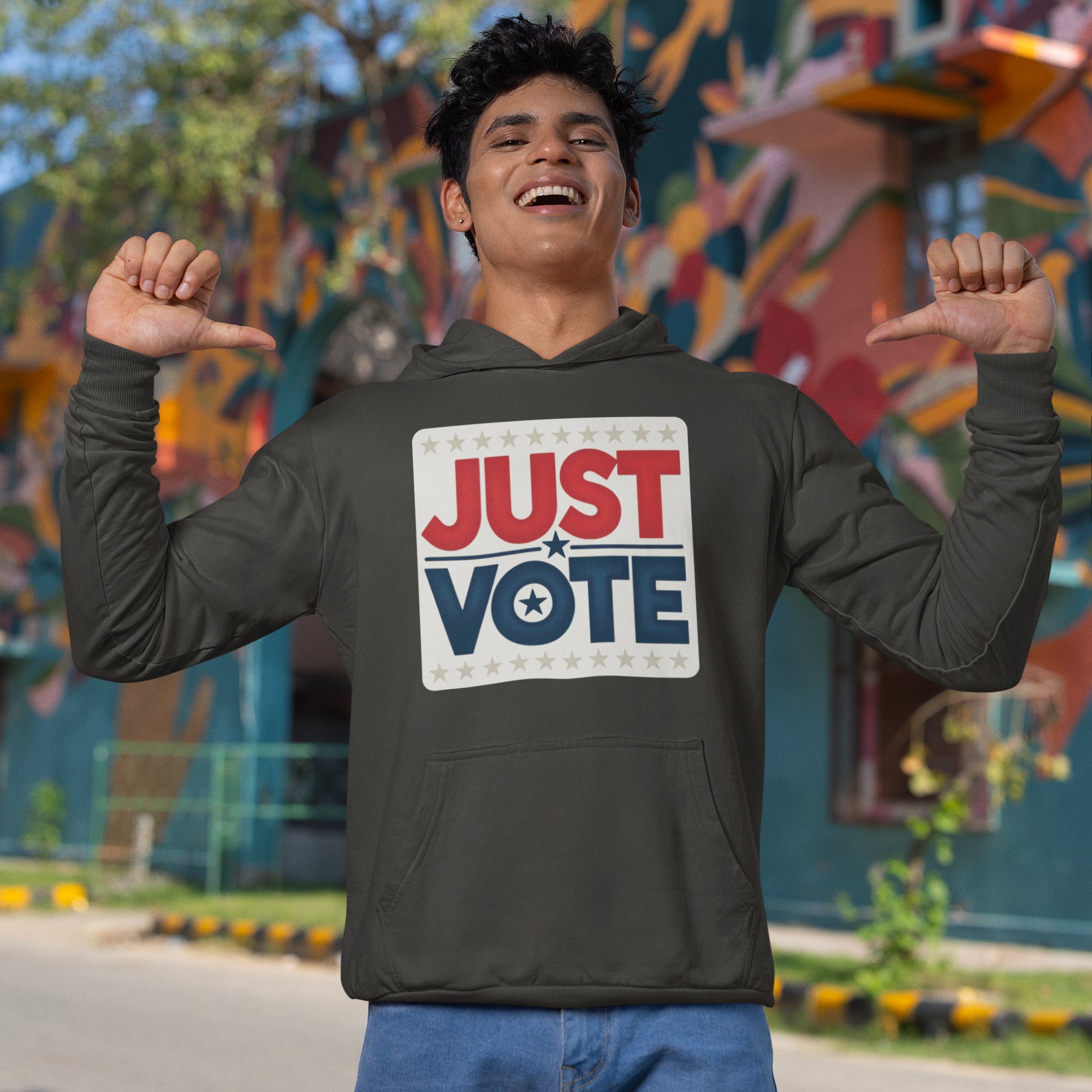 a man wearing a hoodie that says just vote