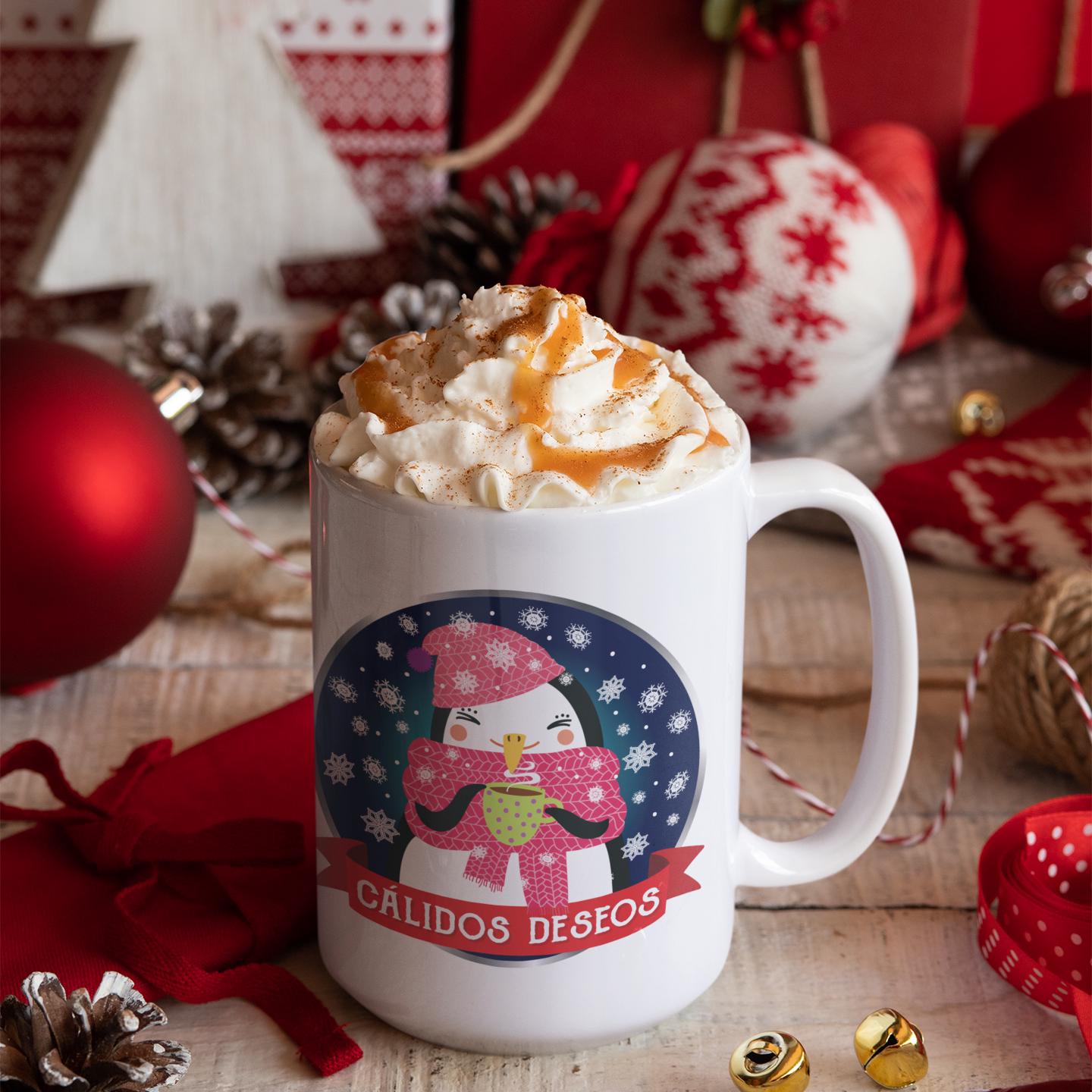 A mug with a snowman design and the text &quot;CALIDOS DESFOS&quot; (Spanish for &quot;Happy Christmas&quot;) is surrounded by Christmas decorations, including ornaments, a red ball, and a pine cone.