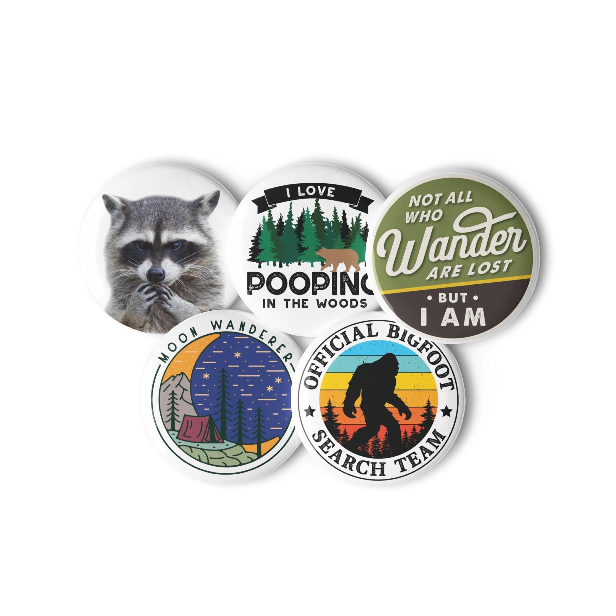 five circular badges with various designs and text, including a raccoon, camping, and a search team.
