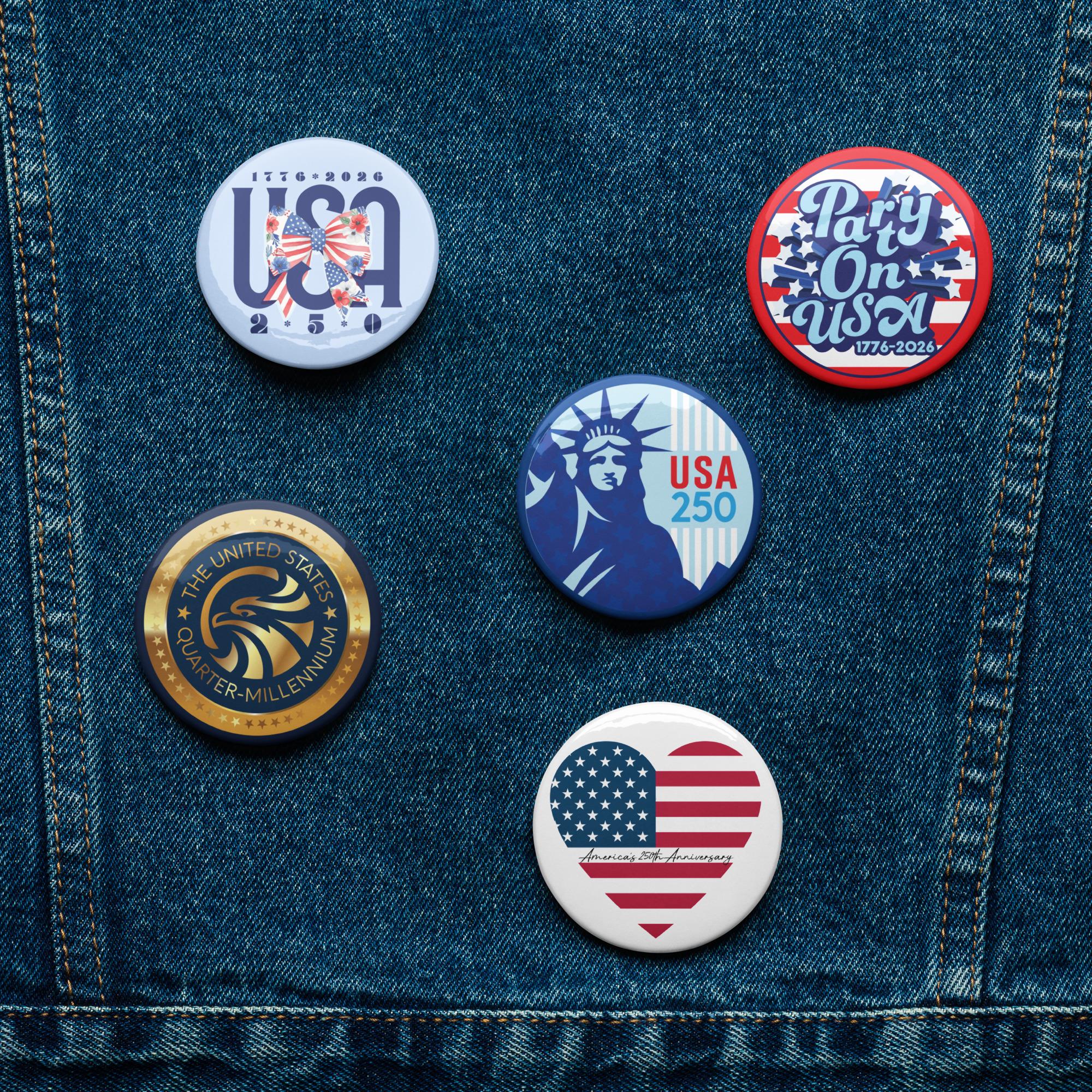 five buttons with patriotic designs, including the Statue of Liberty, the United States flag, and a heart with an American flag.